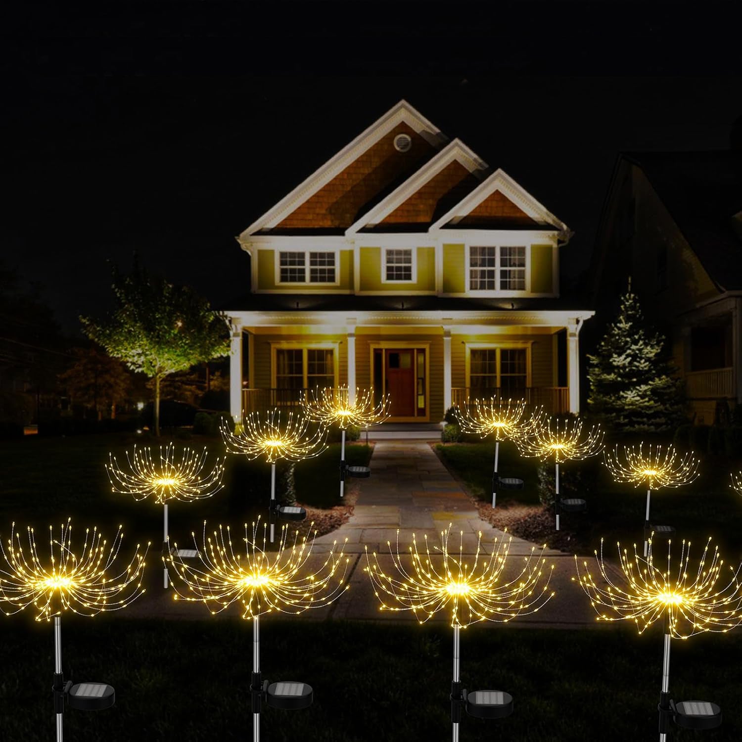 Decorative outdoor lights arranged in front of a house at night.