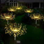 Decorative outdoor lights shaped like sunflowers on a garden path.
