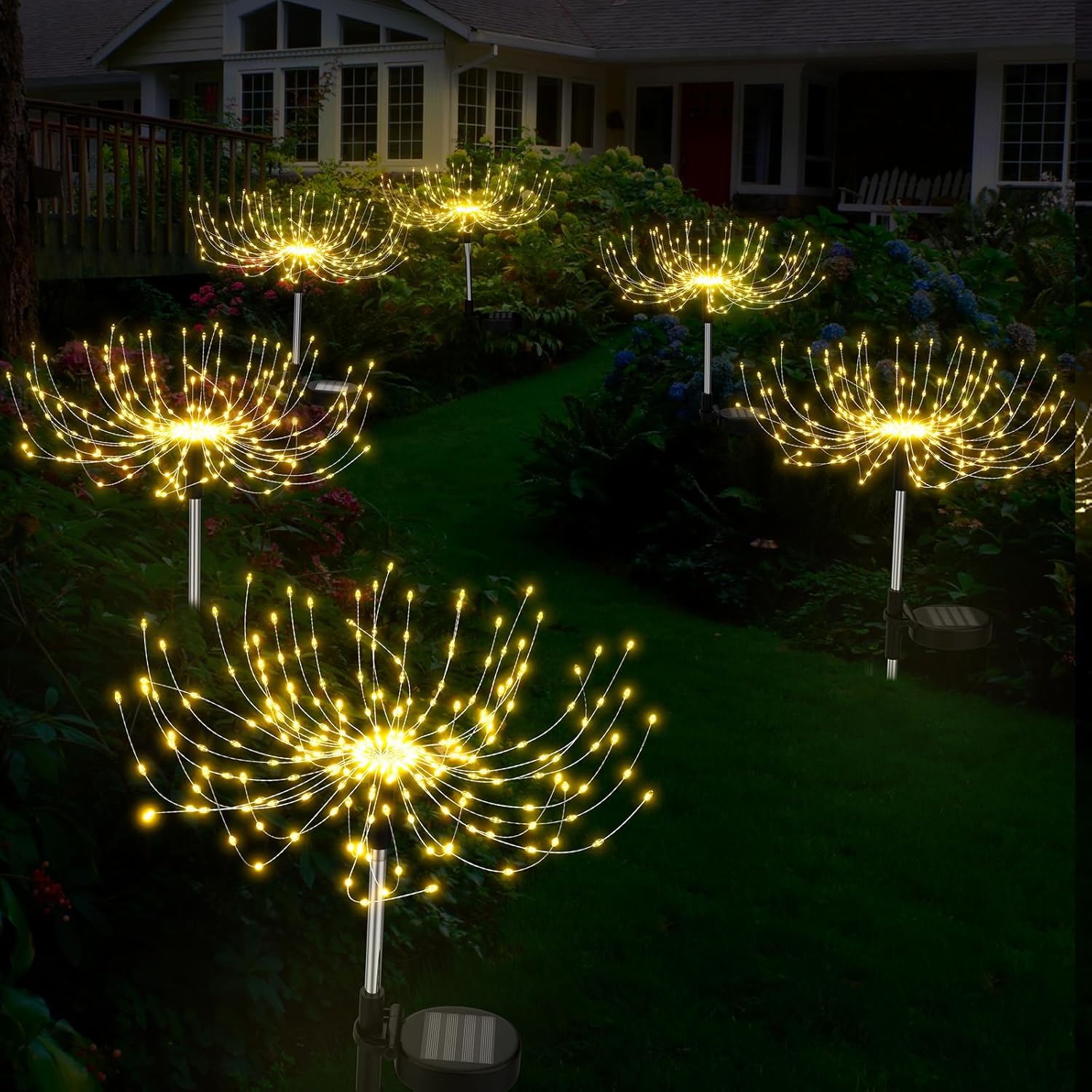 Decorative outdoor lights shaped like sunflowers on a garden path.